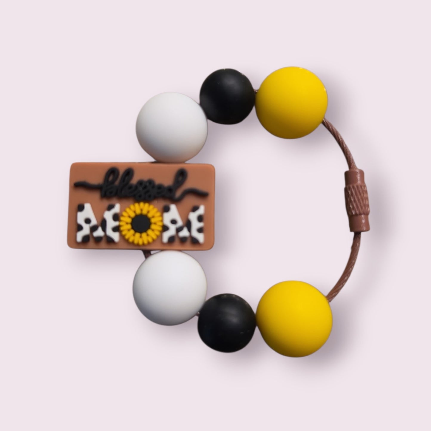 Blessed Mom silicone teething bracelet with sunflower, cow print, and yellow, black, white beads