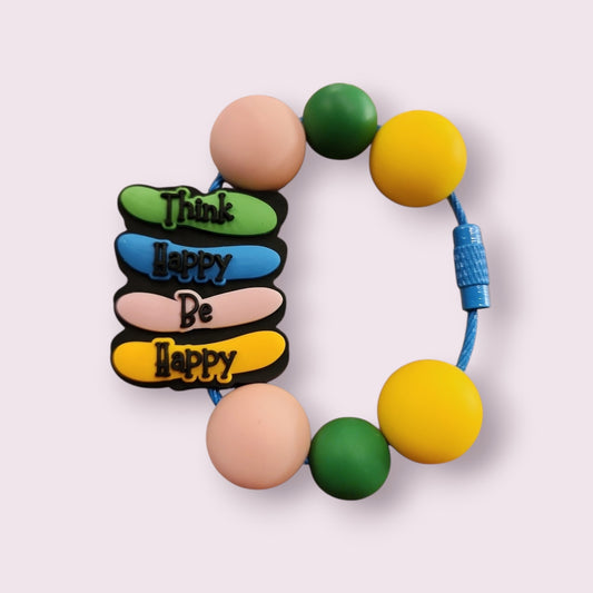 Colorful silicone bracelet with 'Think Happy Be Happy' charm, round beads, and blue cord.