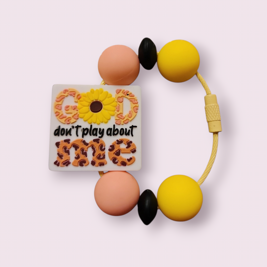 Colorful beaded bracelet with 'God don't play about me' charm, sunflower, and leopard print design