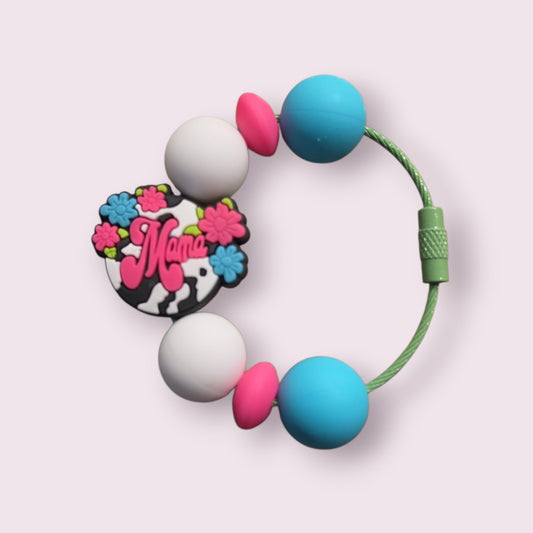 Colorful silicone teething bracelet with 'Mama' charm, floral design, and soft beads for baby comfort.