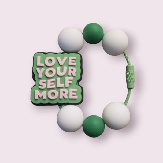 Green and white beaded bracelet with 'Love Your Self More' charm, motivational accessory