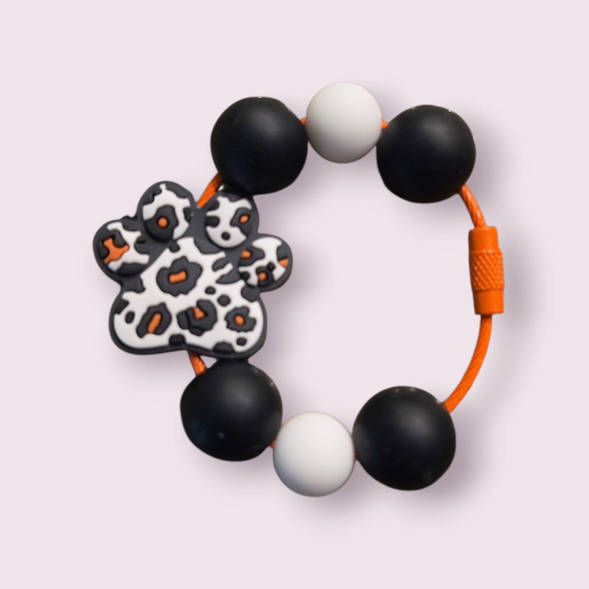 Leopard print paw bracelet with black, white beads and orange cord