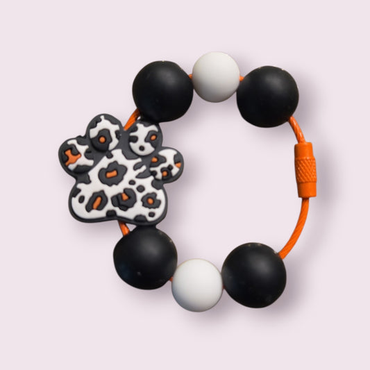 Leopard print paw bracelet with black, white beads and orange cord